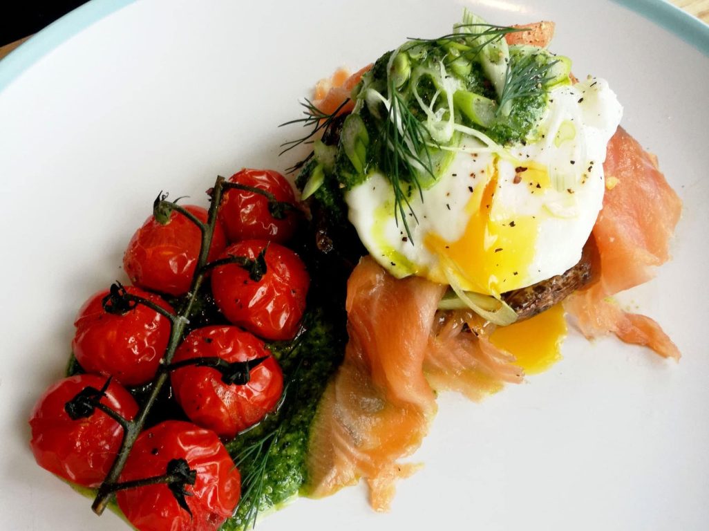 Poached egg breakfast stack with vine tomatoes